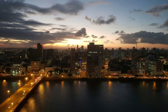 a large body of water with a city in the background